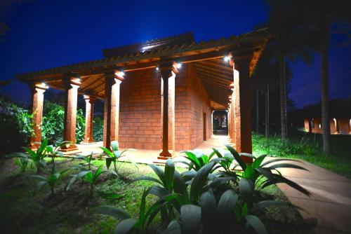 a gazebo with lights on it at night at Hotel Guaminí Misión in Puerto Iguazú
