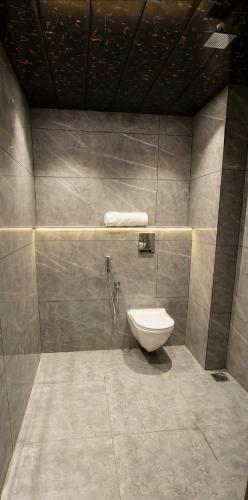 a bathroom with a toilet in the corner at The Royal Height in Nawāda