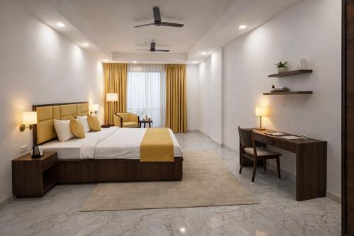 a hotel room with a bed and a desk at The Royal Height in Nawāda
