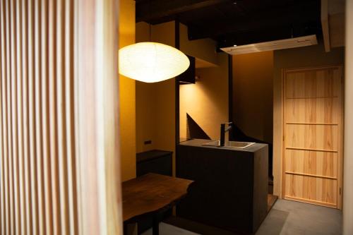 a room with a table and a lamp and a sink at modern villa, asterisk ONOMICHI 2 in Onomichi