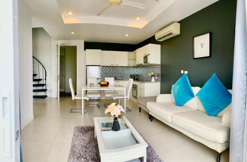 a living room with a white couch and a table at Krabi Boat Lagoon Resort in Krabi