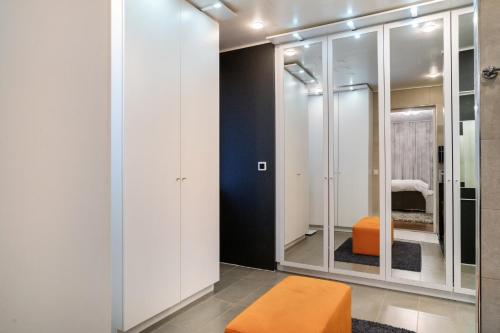 an orange stool in a room with mirrors at Aurora Sky Villa in Rovaniemi