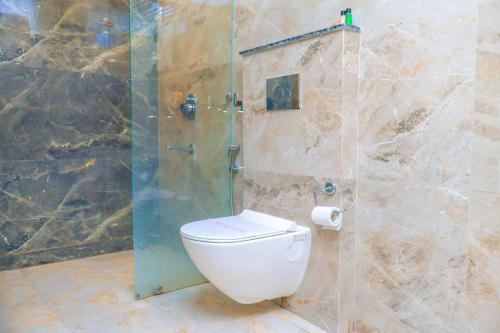 a bathroom with a toilet and a shower at HOTEL HIVE in Mājra
