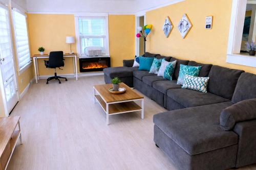 a living room with a couch and a table at CasaViva Pacifica - 2BR Sleeps 10 with Firepit, BBQ & Shared Yard - Walk to Hillcrest Fun, Near Zoo, Balboa Park & Beaches in San Diego