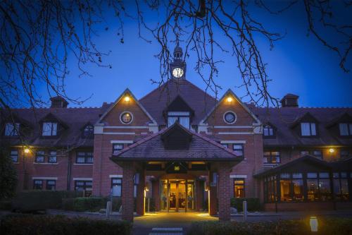 a building with a clock tower on top of it at DoubleTree by Hilton Stratford-upon-Avon, United Kingdom in Stratford-upon-Avon