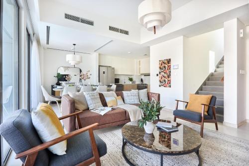 a living room with a couch and chairs at Frank Porter - Nara, The Valley in Dubai