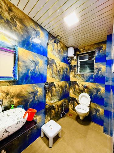 a bathroom with a toilet and a sink at Kohinoor villa in Lonavala