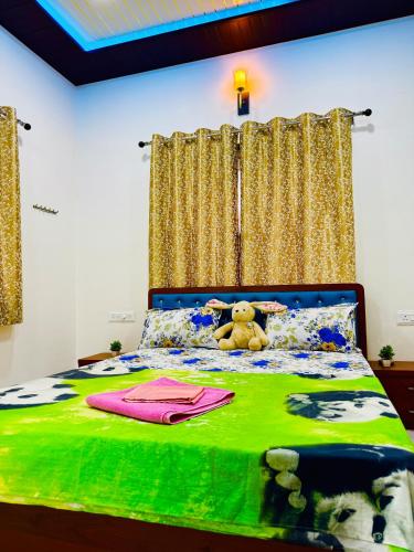 a teddy bear sitting on top of a bed at Kohinoor villa in Lonavala