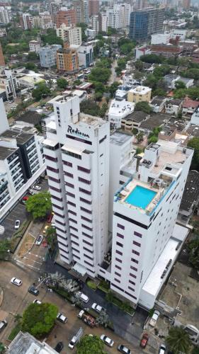 an aerial view of a large white building in a city at Radisson Diamond Barranquilla in Barranquilla