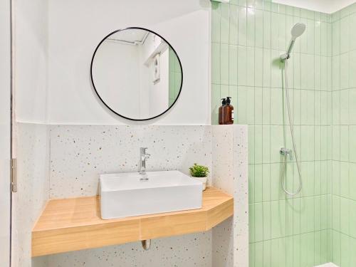 a bathroom with a white sink and a mirror at 8 Min Walk to IconSiam I BTS near Pier in Bangkok