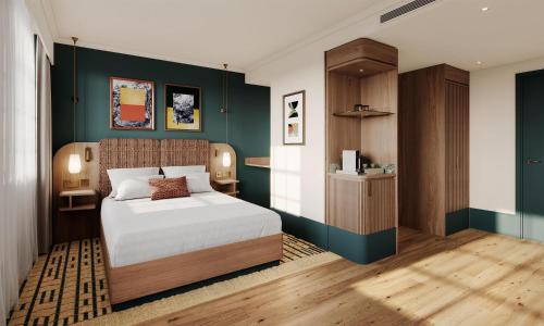 a bedroom with a bed and a green wall at The Derby London City, Curio Collection By Hilton in London