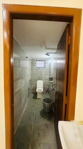 a bathroom with a toilet and a sink at Vishwa Adithya Service Apts in Venkatāpur