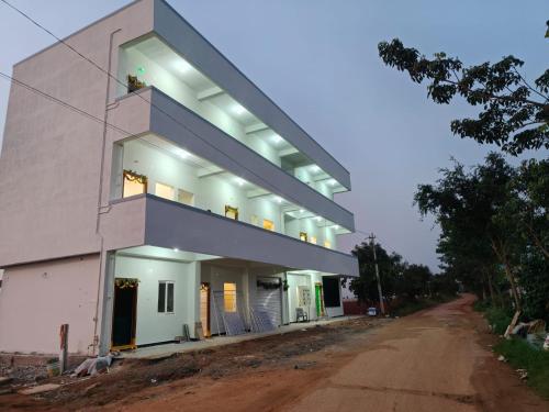 a house on the side of a dirt road at Vishwa Adithya Service Apts in Venkatāpur