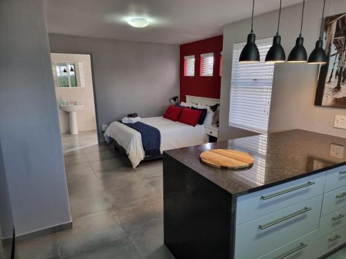 a bedroom with a bed and a kitchen with a counter at Langebaan Beach Towers in Langebaan