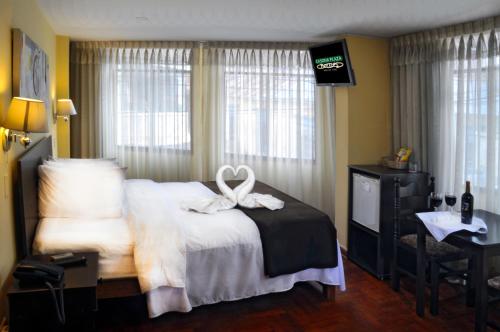 a hotel room with a bed with a ribbon on it at Casona Plaza Hotel Centro in Puno