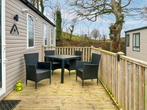 a patio with chairs and a table on a deck at Seren - Uk51711 in Cockermouth