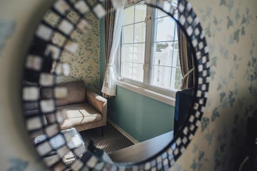 a mirror in a room with a chair and a window at 伊豆集 Episode IZU in Ito