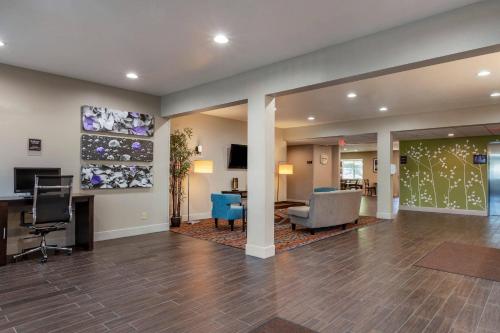 a lobby with a waiting area with a desk and chairs at Sleep Inn & Suites Kalamazoo Southwest in Kalamazoo