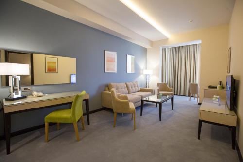 a living room with a couch and a table and chairs at Ararat Resort Tsaghkadzor in Tsaghkadzor
