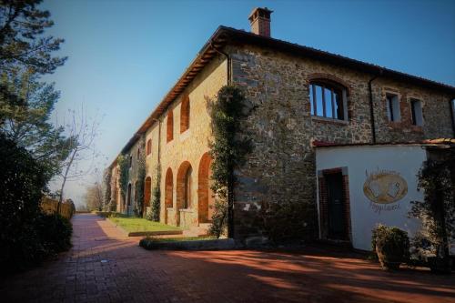 an old stone building on a brick road at Agriturismo Antico Borgo Poggitazzi in Loro Ciuffenna
