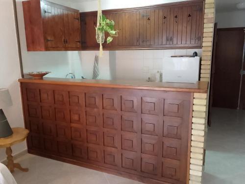 a kitchen with wooden cabinets and a counter top at Cala Morelló in Ifach