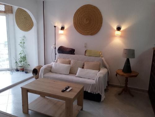 a living room with a couch and a table at Cala Morelló in Ifach