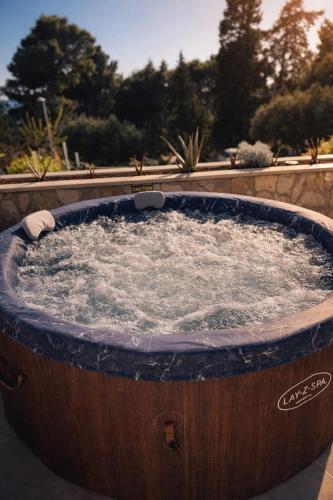 a large wooden tub with water in it at Holiday Home Lungo Mare in Mlini