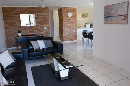 a living room with a couch and a table at Kabi Apartment Caloundra - Self Contained in Golden Beach