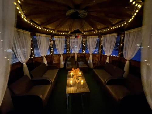 a room with couches and a table and lights at Vintage House in Elena