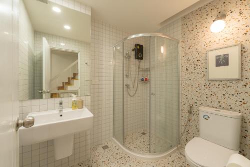 a bathroom with a shower and a sink and a toilet at Tungyu Home Old Town - 1 min to walking street in Chiang Mai