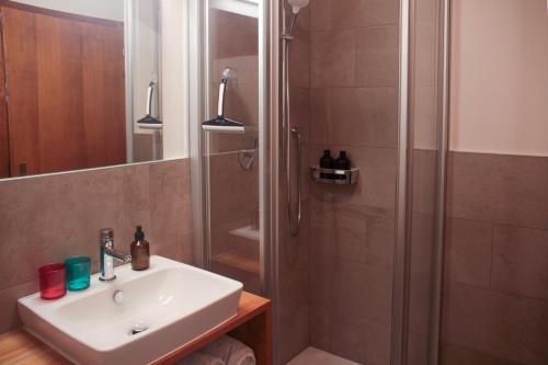 a bathroom with a sink and a shower at mösslerhof in Aldino