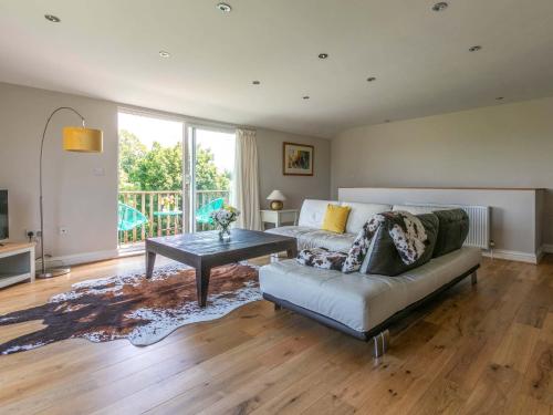 a living room with a couch and a table at Riverside in Stone