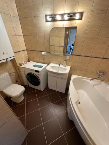 a bathroom with a sink and a toilet and a sink at Vievis Hotel Vievija in Vievis