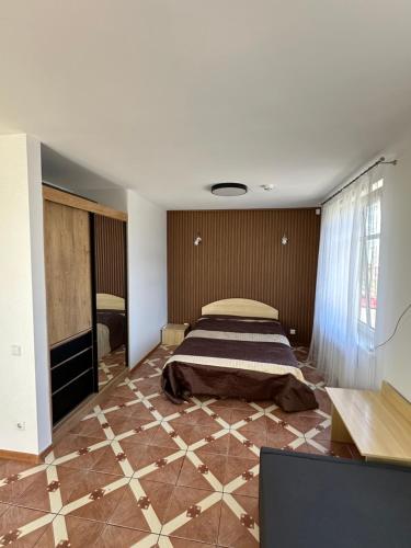 a bedroom with a bed in the middle of a room at Vievis Hotel Vievija in Vievis