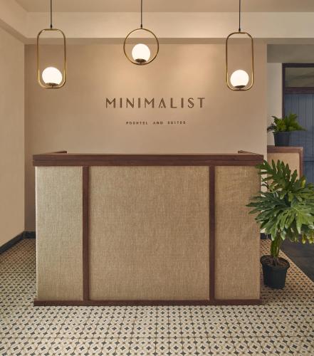 a reception desk in a lobby with potted plants at Minimalist Poshtel & Suites in New Delhi