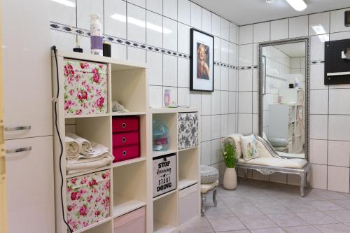 ein Badezimmer mit weiß gefliesten Wänden und weißen Regalen in der Unterkunft Hostel LR in Nazarje