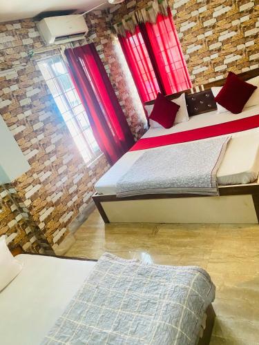 a bedroom with two beds and a brick wall at Global hotel in Pānigata