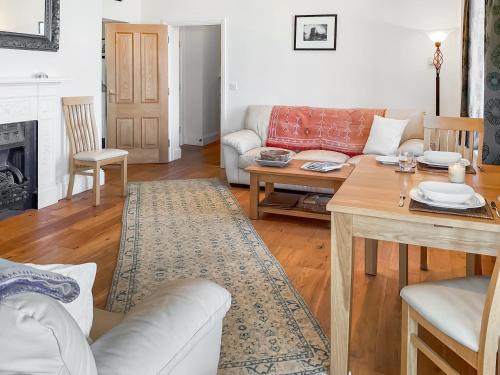 a living room with a couch and a table at Flat 4 Sea Court in Swanage