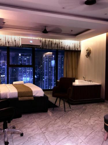 a hotel room with a bed and a bath tub at Hotel Namaste With Jacuzzi I Best For Couples and Corporate I Noida in Noida