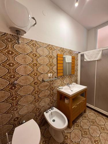 a bathroom with a toilet and a sink at MONOLOCALI DA VINCI in Falconara Marittima