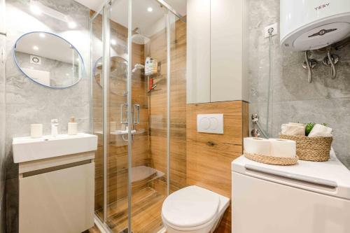 a bathroom with a toilet and a glass shower at Stella Andrea Luxury Apartment in Bar