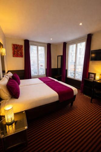 a bedroom with a large bed with red curtains at Hotel Pax Opera in Paris