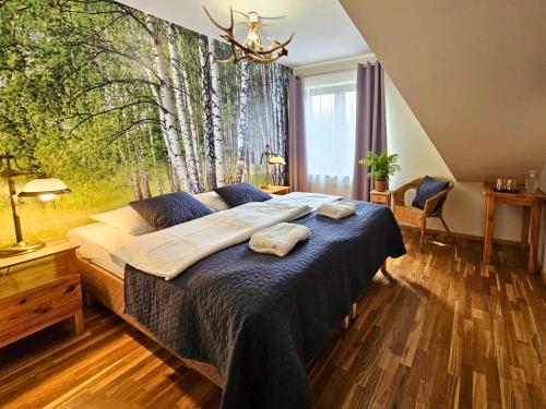 a bedroom with a bed with two towels on it at Balia Spa & Wellness in Kazimierz Dolny