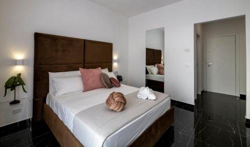a bedroom with a large bed with a wooden headboard at Hotiday Pozzuoli in Pozzuoli
