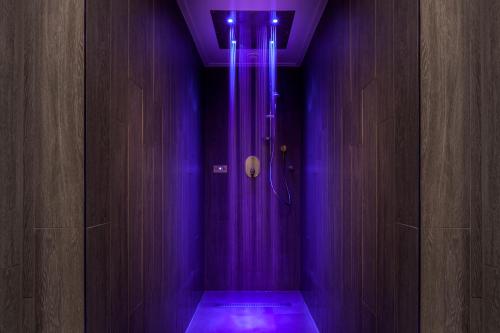 a purple bathroom with a shower with purple lights at Langdale Hotel & Spa in Ambleside