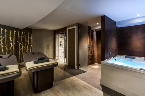 a bathroom with a tub and a sink at Langdale Hotel & Spa in Ambleside