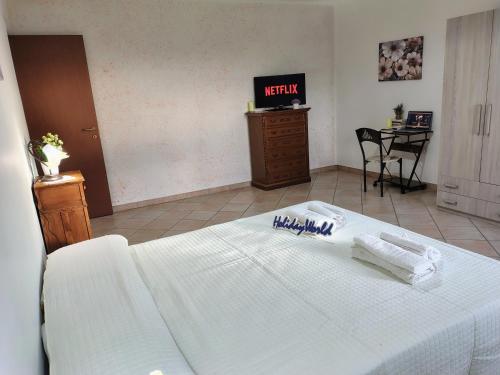 a bedroom with a white bed and a table at Casa Gioele by Holiday World in Bove