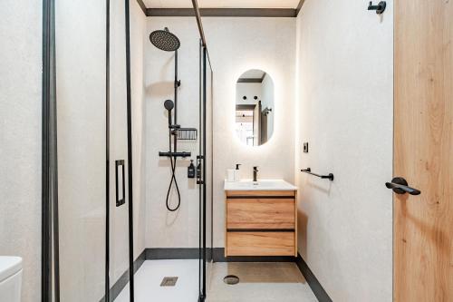 a bathroom with a shower and a sink at Elcano Suites in Seville