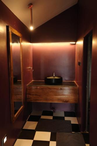 a bathroom with a sink and a mirror at Outside Space Resorts in Lovedale