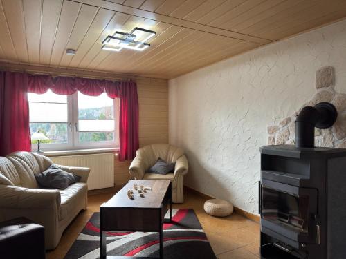 a living room with a couch and a table at Ferienhaus in Altenfeld Thüringen mit Garten in Altenfeld